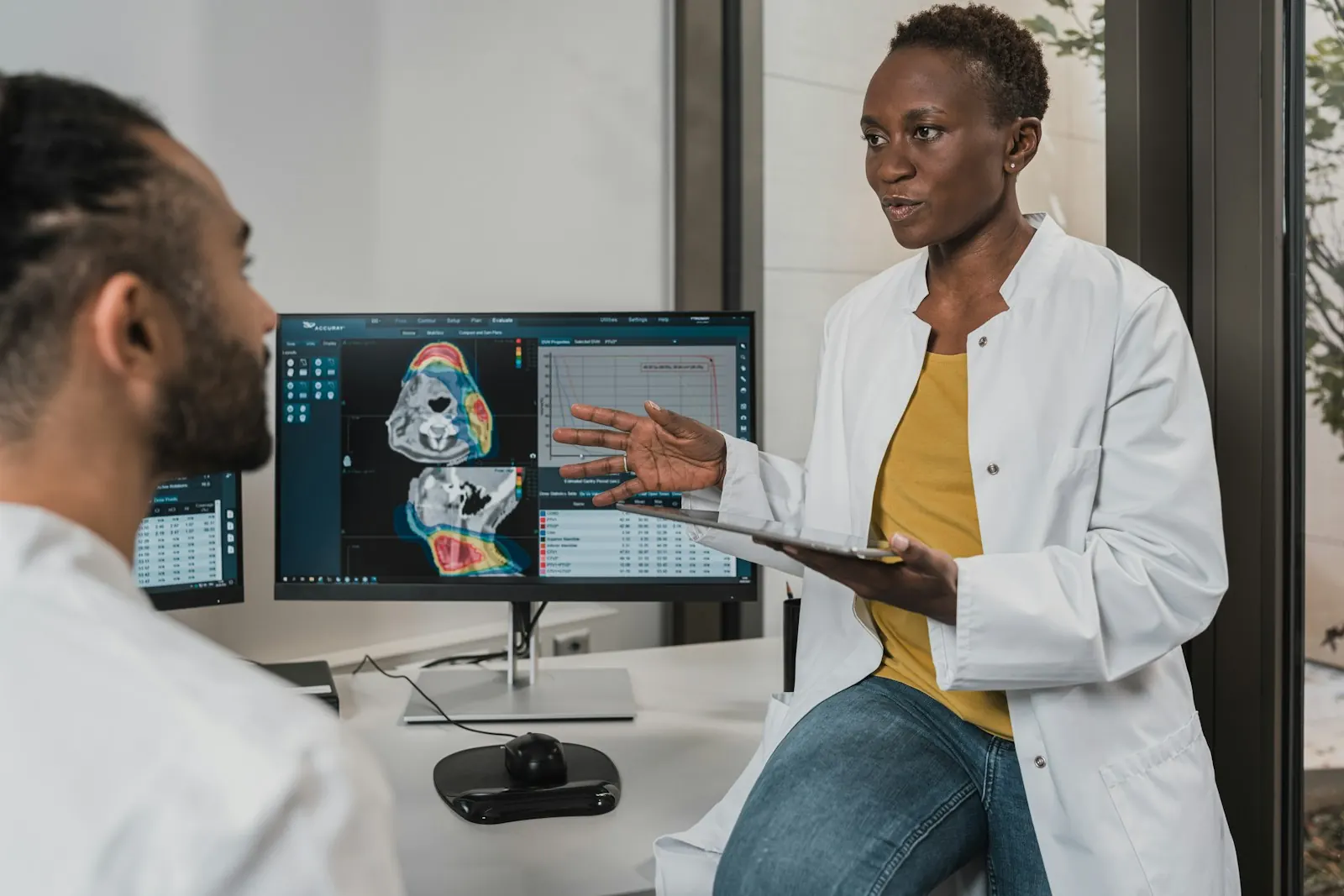 A clinician reviews a scan on a computer screen.