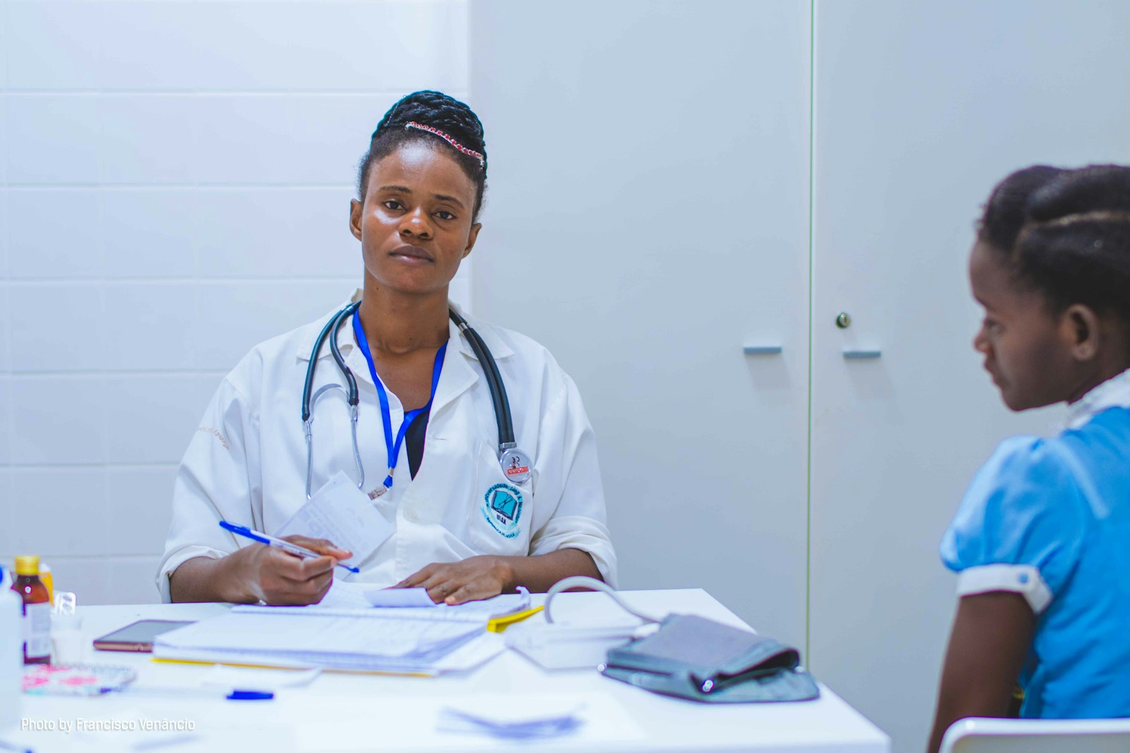 A doctor listening to a patient during a consultation